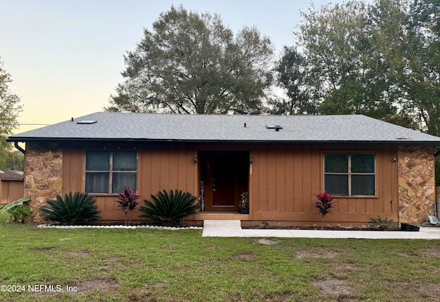 ranch-style house with a yard