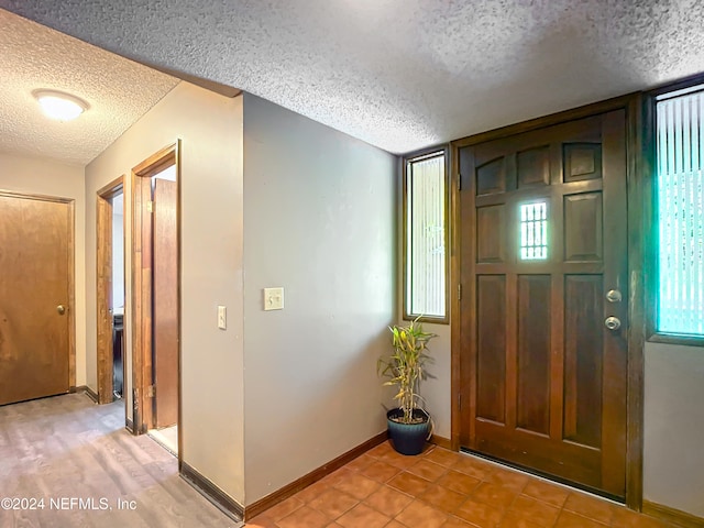 foyer entrance featuring a textured ceiling