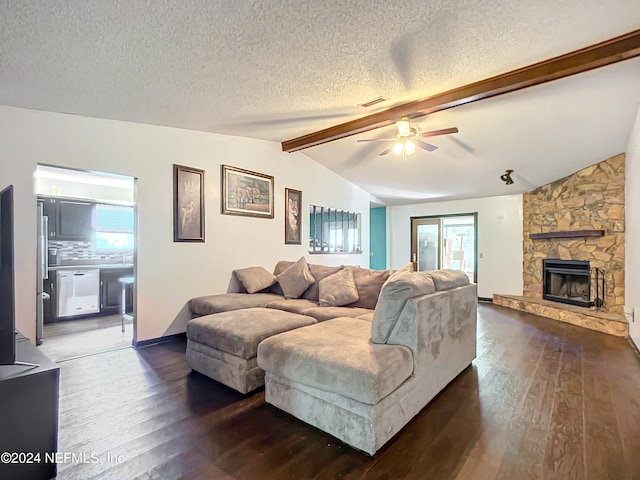 living room featuring a textured ceiling, ceiling fan, a fireplace, vaulted ceiling with beams, and dark hardwood / wood-style floors