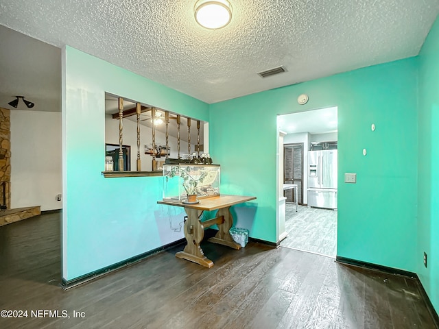 interior space with hardwood / wood-style floors and a textured ceiling