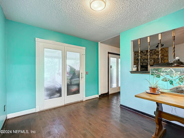 entryway featuring a textured ceiling and dark wood-type flooring