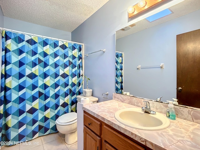 bathroom featuring tile patterned flooring, vanity, a textured ceiling, and toilet