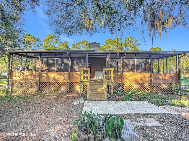 exterior space featuring a sunroom