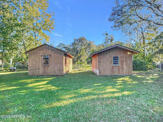 view of outbuilding with a yard