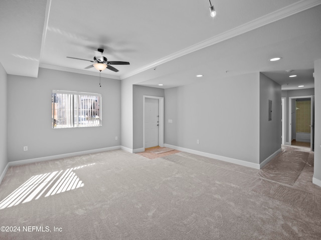 empty room with light carpet, ceiling fan, and ornamental molding