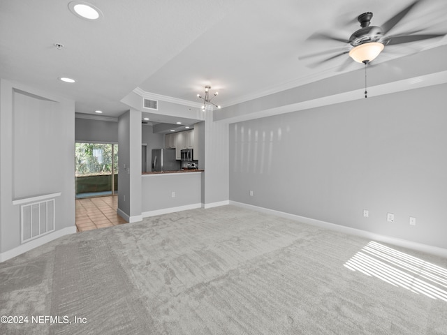 unfurnished living room featuring ceiling fan, ornamental molding, and light carpet