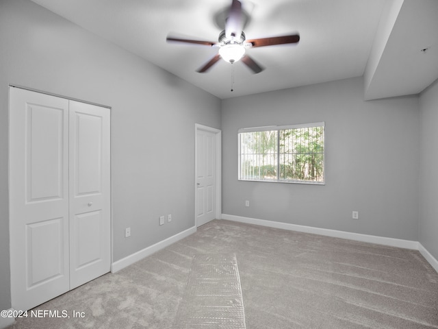 unfurnished bedroom with light carpet and ceiling fan