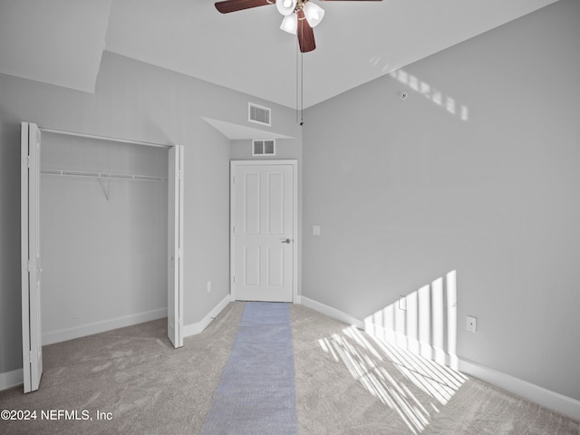 unfurnished bedroom featuring ceiling fan, light colored carpet, and a closet