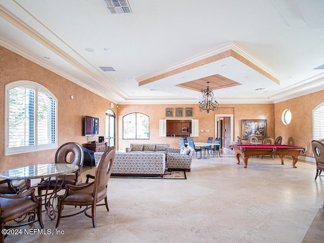 living room with a tray ceiling, an inviting chandelier, ornamental molding, and pool table