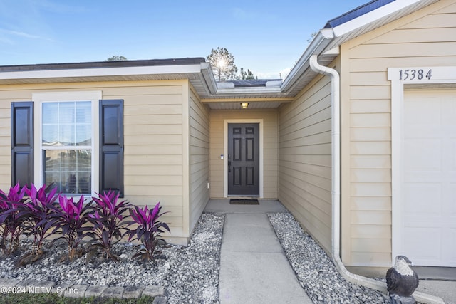 doorway to property featuring a garage