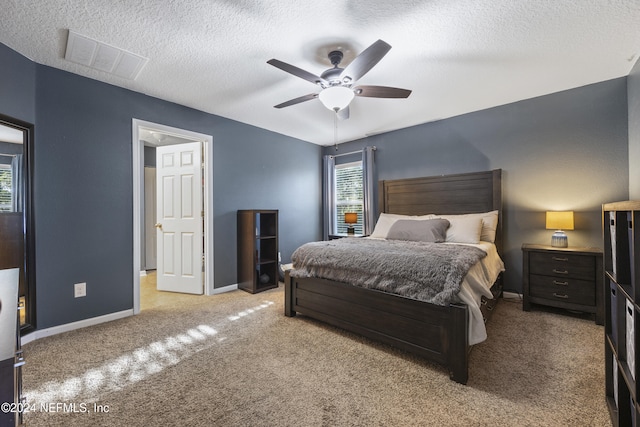 carpeted bedroom featuring a textured ceiling and ceiling fan