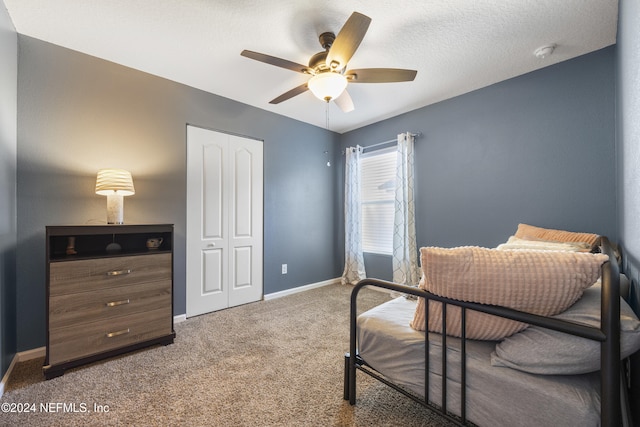 interior space with ceiling fan, a textured ceiling, and a closet