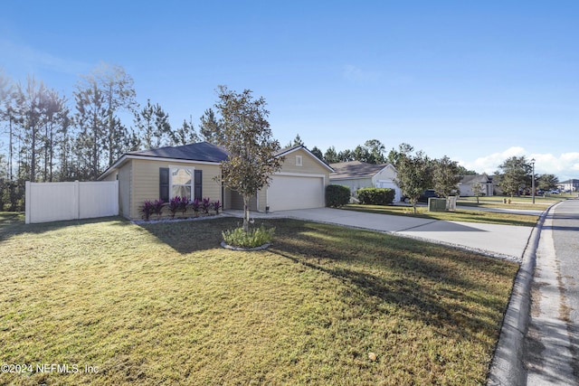 single story home with a garage and a front lawn