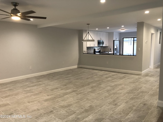 interior space with sink, ceiling fan, and light wood-type flooring