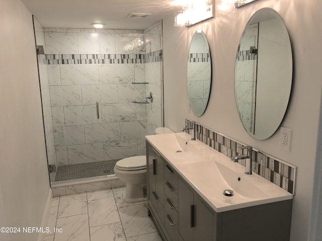 bathroom with a shower with door, vanity, and toilet