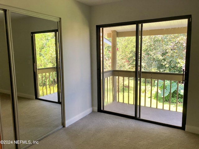 entryway featuring light colored carpet