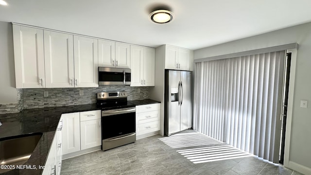 kitchen with appliances with stainless steel finishes, sink, and white cabinets