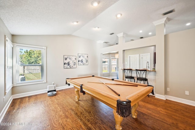 game room with a wealth of natural light, hardwood / wood-style floors, vaulted ceiling, and pool table