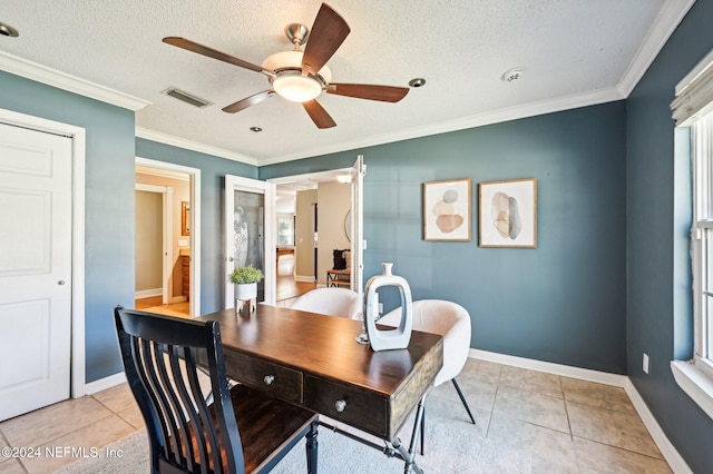 tiled dining space featuring a textured ceiling, ceiling fan, and crown molding