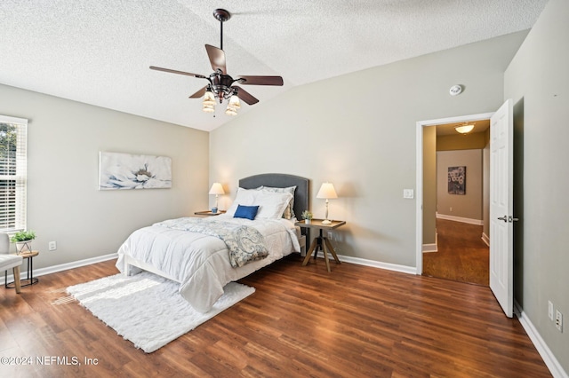 bedroom featuring a textured ceiling, lofted ceiling, ceiling fan, and dark wood-type flooring