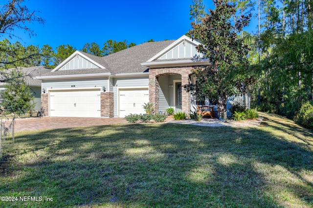 view of front of property with a front yard and a garage