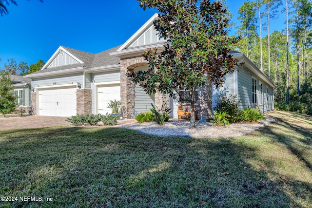 view of front facade with a front yard and a garage