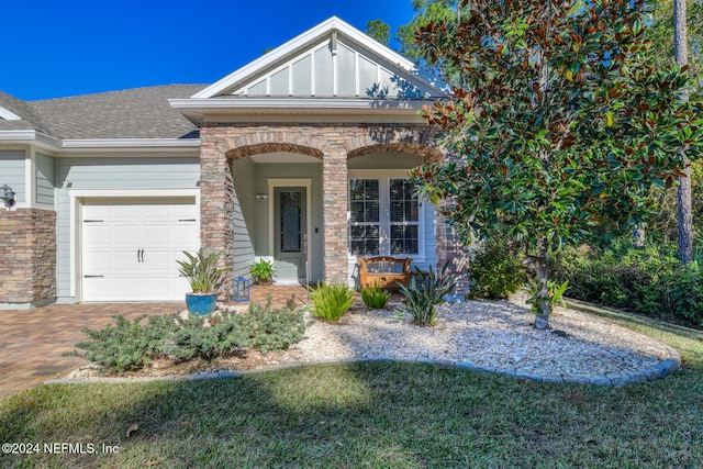 view of front of property featuring a porch and a garage