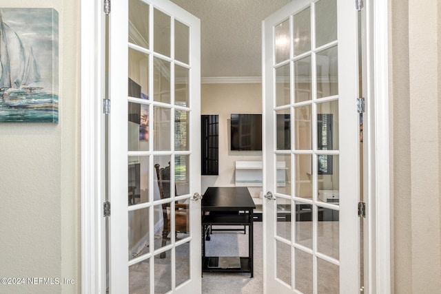 interior space featuring crown molding, french doors, and a textured ceiling