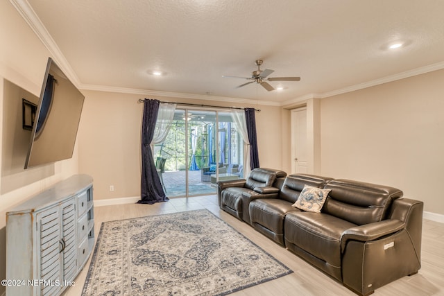 living room featuring ceiling fan, light wood-type flooring, and ornamental molding