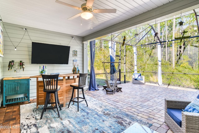 view of patio with a bar and ceiling fan