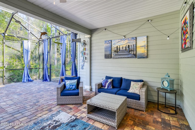 view of patio featuring glass enclosure and an outdoor living space