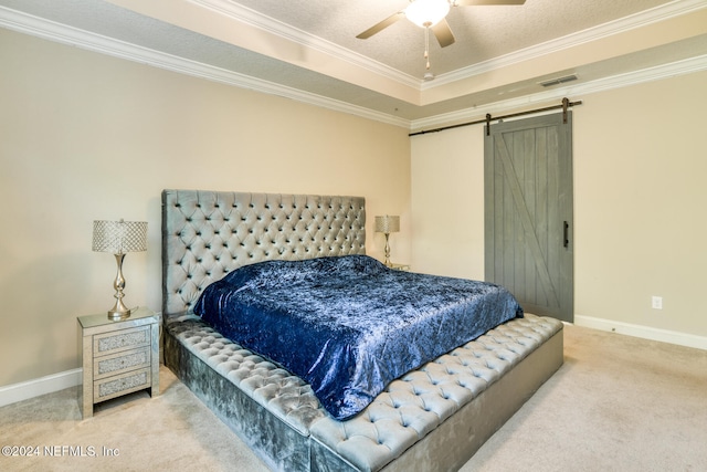 bedroom featuring a barn door, ceiling fan, carpet, and ornamental molding