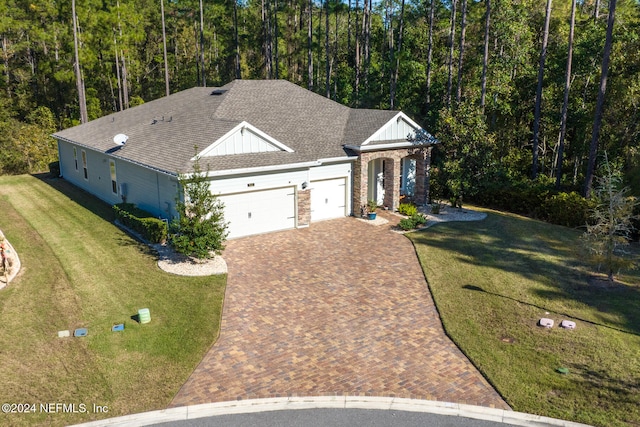 view of front of property featuring a garage and a front yard