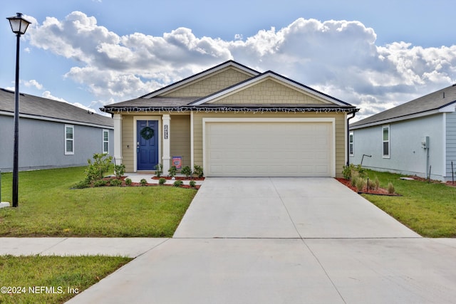 view of front of property with a garage and a front lawn