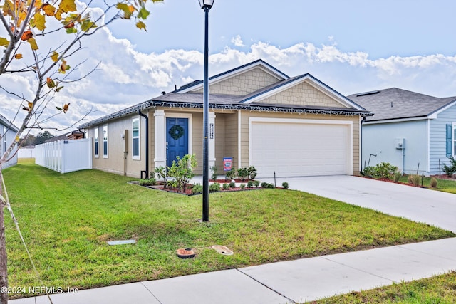 view of front of property featuring a garage and a front lawn