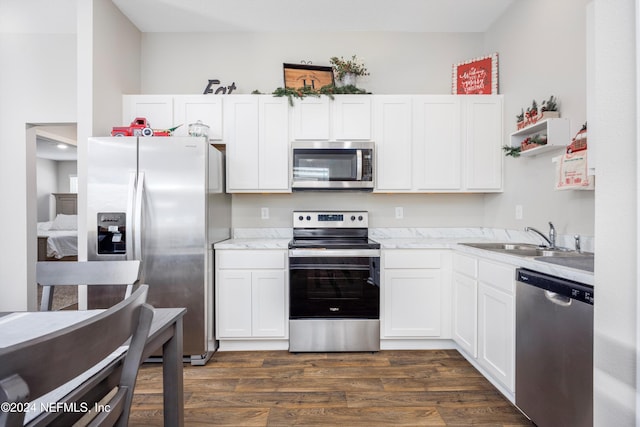 kitchen featuring stainless steel appliances, white cabinetry, dark wood-type flooring, and sink