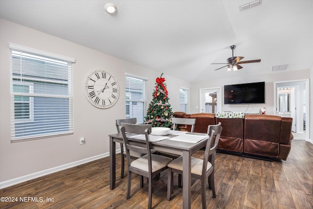 dining area featuring ceiling fan, dark hardwood / wood-style flooring, and vaulted ceiling