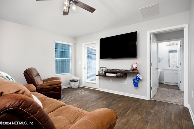 living room featuring ceiling fan and dark hardwood / wood-style floors