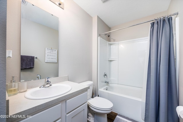 full bathroom featuring vanity, a textured ceiling, shower / tub combo with curtain, hardwood / wood-style flooring, and toilet