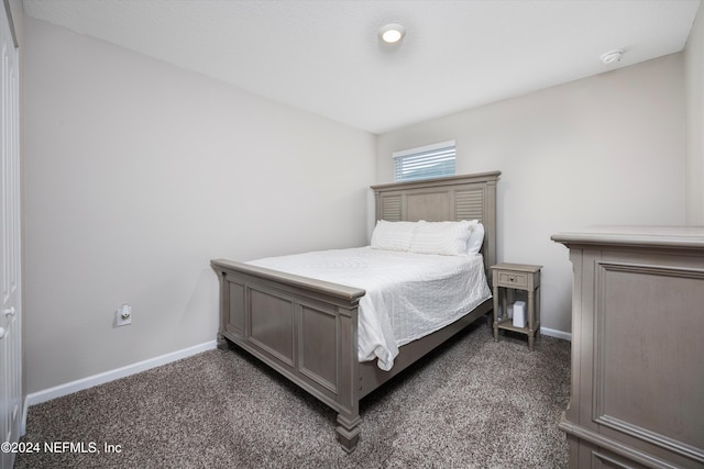 bedroom with dark colored carpet