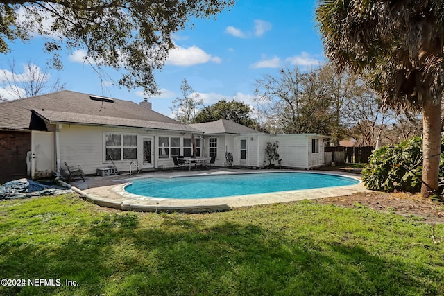 view of swimming pool featuring a yard and a patio