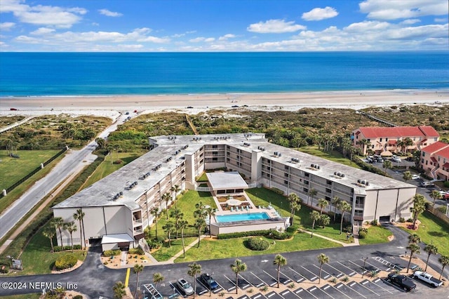 birds eye view of property with a water view and a view of the beach