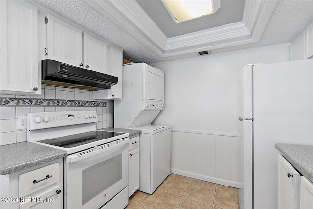 kitchen featuring white appliances, white cabinets, decorative backsplash, ornamental molding, and stacked washer / drying machine