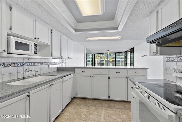 kitchen featuring white appliances, ceiling fan, a textured ceiling, tasteful backsplash, and white cabinetry