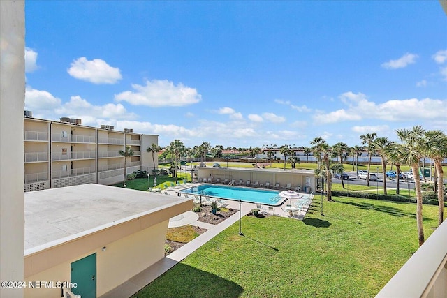 view of pool with a lawn and a patio