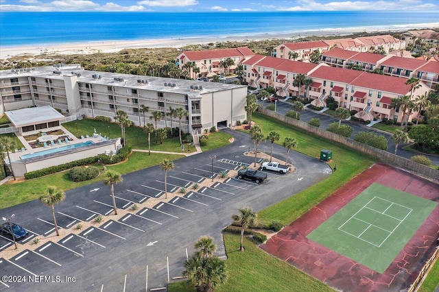 birds eye view of property with a water view and a view of the beach