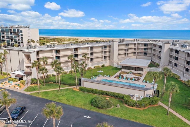 birds eye view of property featuring a water view and a beach view