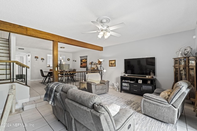 living room with light tile patterned floors, a textured ceiling, and ceiling fan