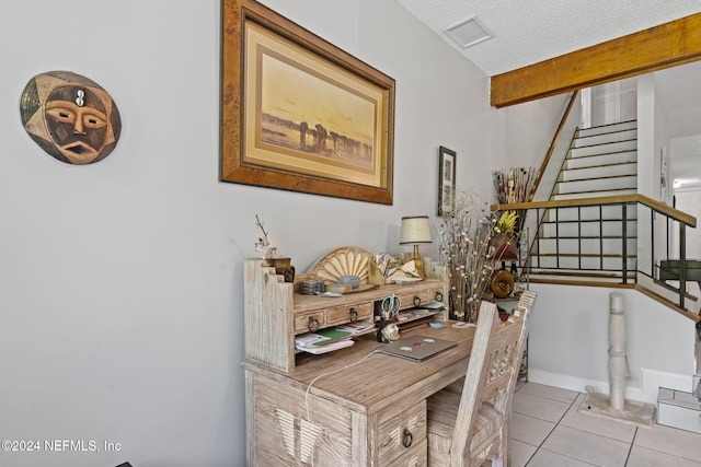 home office featuring light tile patterned flooring and a textured ceiling