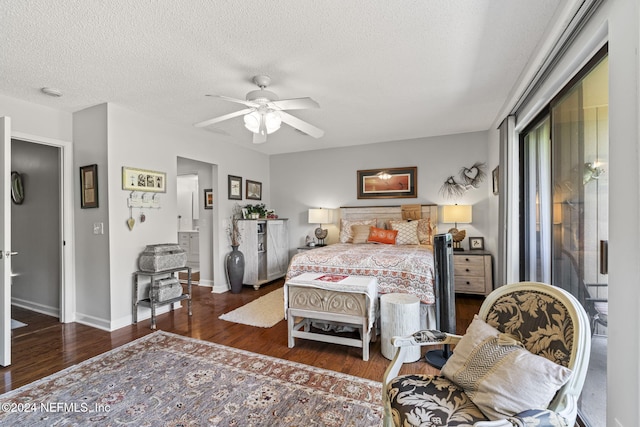 bedroom featuring ceiling fan, dark hardwood / wood-style flooring, and a textured ceiling